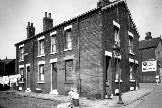 Two boys stand with a child's pram at the corner of Temple View Place and Temple View Road in July 1963.