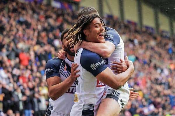Dom Young celebrates his first half try with Jack Welsby and Kallum Watkins. Picture by Alex Whitehead/SWpix.com.