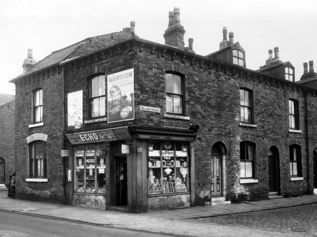 This is looking across Sackville Street to Belfort Street in October1960. On the left Belfort Place is just visible. Number 38 Sackville Street is the business of J. Baxter selling groceries.
