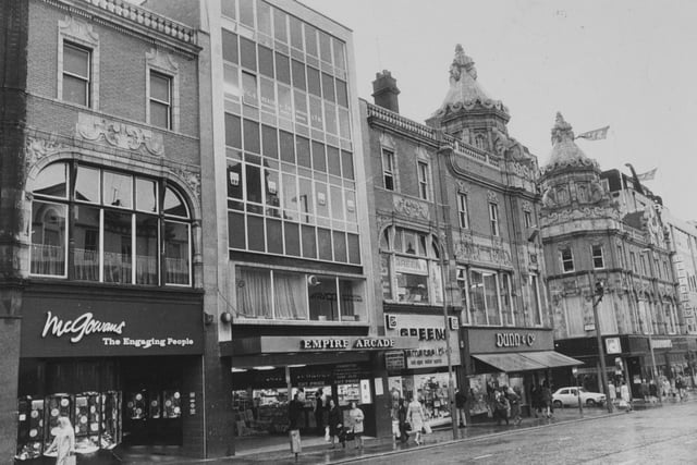Briggate in July 1974. In focus are  McGowans, Empire Arcade, Greens and Dunn & Co.