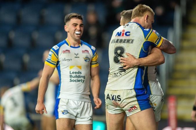 Jack Sinfield and Mikolaj Oledzki celebrate with Mickael Goudemand after he touched down at the start of the second half.