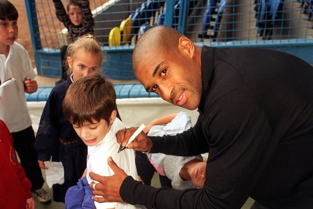 Leeds United striker Brian Deane signs an autograph for a young fan from Broom Hill Family Centre in Harehills during the launch of the 1996 Yorkshire Young Achiever Awards at Elland Road.