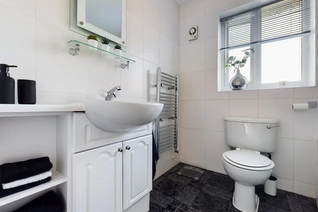 The family bathroom is fitted with a three piece suite in white, hand wash basin and panelled bath with an overhead shower. There are part-tiled walls, a radiator, extractor fan and Upvc double glazed windows.