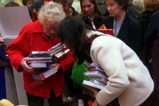 December 1999 and bargain-hunters indulge in the great British tradition of battling to buy next year's Christmas cards.
