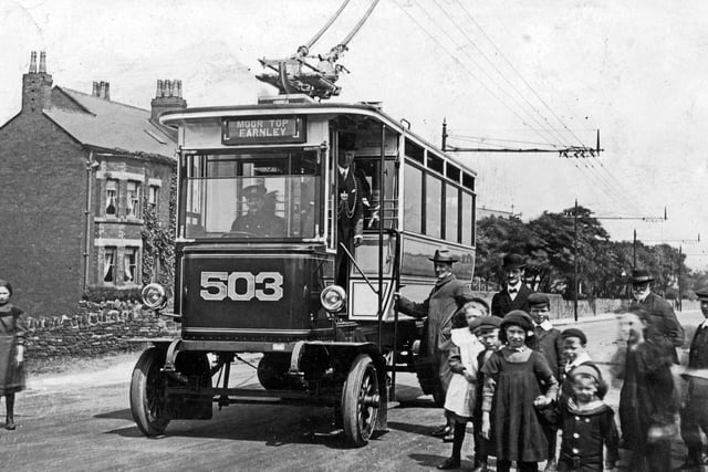 Trackless car number 503 at Moor Top in Farnley, at the junction of Whitehall Road and Lawns Lane. Car 503 was one of two serving the route, along with car 501,and is pictured after the inaugural journey and opening of the Bradford and Leeds rail-less trolley car systems on June 20, 1911. Leeds Lord Mayor, William Middlebrook MP, can be seen standing in the doorway of the car.