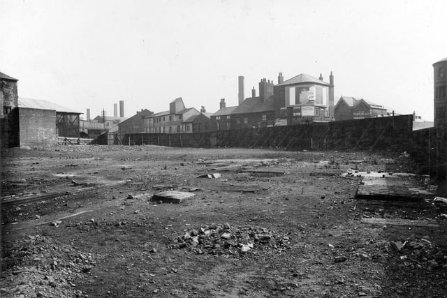 Waste land looking towards Crown Point area. In the background can be seen Hudsons's Sawmills, three factory chimneys and buildings along East Street and junction of Crown Point Road. Pictured in August 1936.