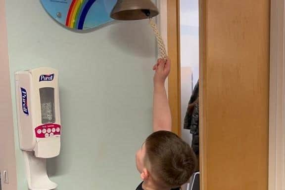 BIG MOMENT - Leeds United fan Eddie Franks ringing the bell to signal the end of his treatment