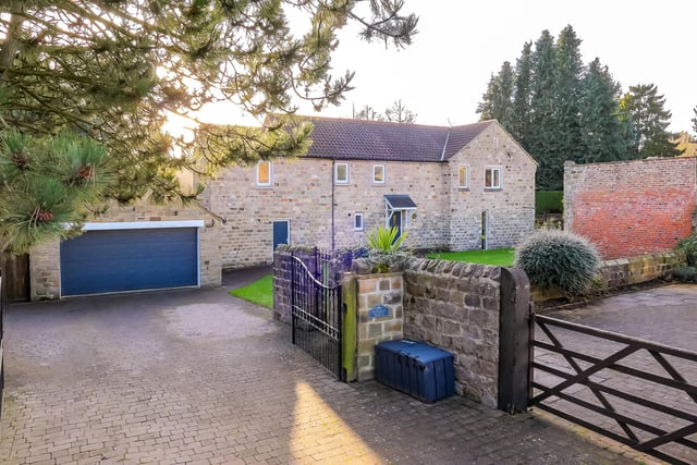 Gated entry to the property, with its double garage.
