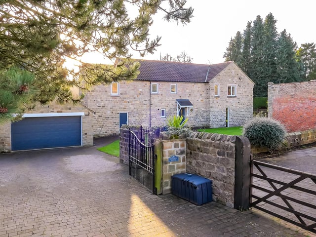 Gated entry to the property, with its double garage.