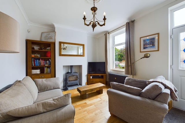 The spacious living room at the front of the property provides plenty of space to relax and enjoy the charming period home.
