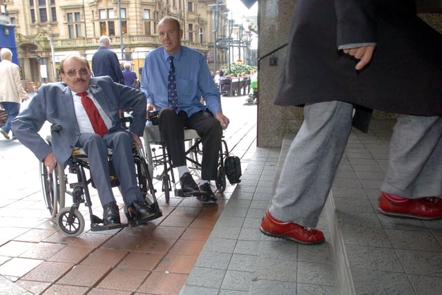 Disabled Rights Commission chair Bert Massie, left, joins David Littlewood, from Leeds, in Leeds city centre to protest against inadequate access to banks and shops for disabled people in September 2004.