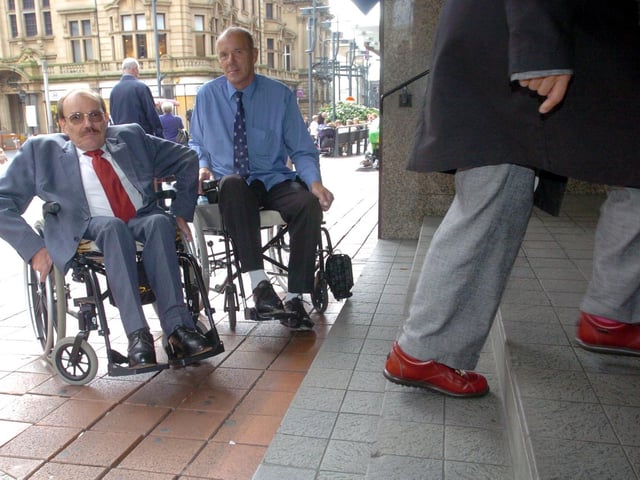 Disabled Rights Commission chair Bert Massie, left, joins David Littlewood, from Leeds, in Leeds city centre to protest against inadequate access to banks and shops for disabled people in September 2004.