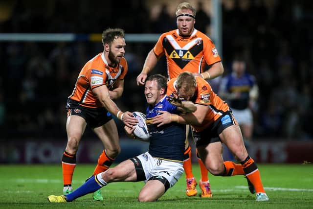 Luke Gale and Paul McShane, then of Castleford Tigers, tackle Leeds Rhinos' Danny McGuire during a Super League derby at Headingley in 2015. All three will be on the same side this weekend. Picture by Alex Whitehead/SWpix.com.