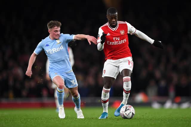 Nicolas Pepe makes a break past Robbie Gotts during the FA Cup third round match between Arsenal and Leeds United at the Emirates Stadium on January 06, 2020 in London, England.