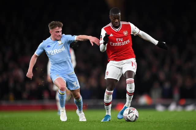 Nicolas Pepe makes a break past Robbie Gotts during the FA Cup third round match between Arsenal and Leeds United at the Emirates Stadium on January 06, 2020 in London, England.