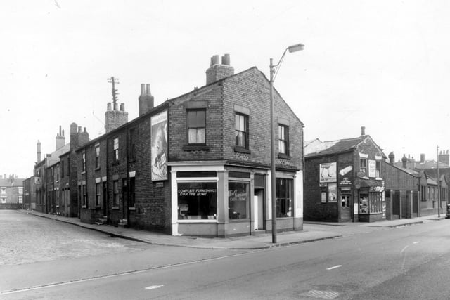 The even numbered side of Dawson Street run from the left edge of this view in descending order. Number 10 Elland Road is at the end of this view in descending order. Number 10 Elland Road is at the end of this row and is a furniture store, Ultra Furnishings. New Princess Street follows to the right, then J. Miller, grocer and general dealer at number 8 Elland Road with Holbeck Sorting Office on the right edge. Pictured in April 1959.