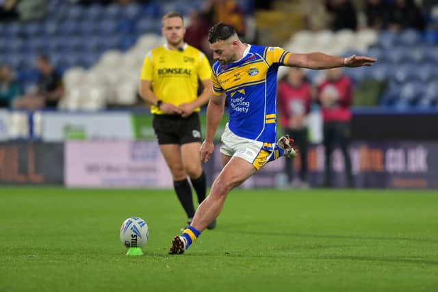 Referee Tom Grant watches on as Jake Connor boots a goal for Leeds Rhinos in last month's win at Huddersfield Giants. Picture by Jonathan Gawthorpe.