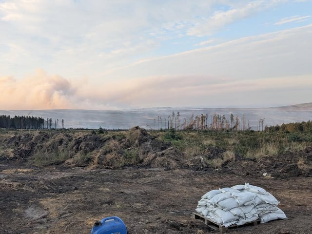 The fire at Langdale Moor, close to the RAF Fylingdales early warning base, has forced road closures and triggered warnings from the authorities for people to stay away.