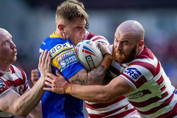 Liam Sutcliffe is tackled by Liam Farrell, left and Jake Bibby during Rhinos' win over Wigan. Picture by Allan McKenzie/SWpix.com.
