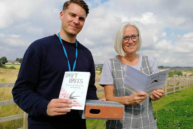 Coun James Gibson and Helen Lucy. Coun Gibson is holding both Helen's book and a swift brick.