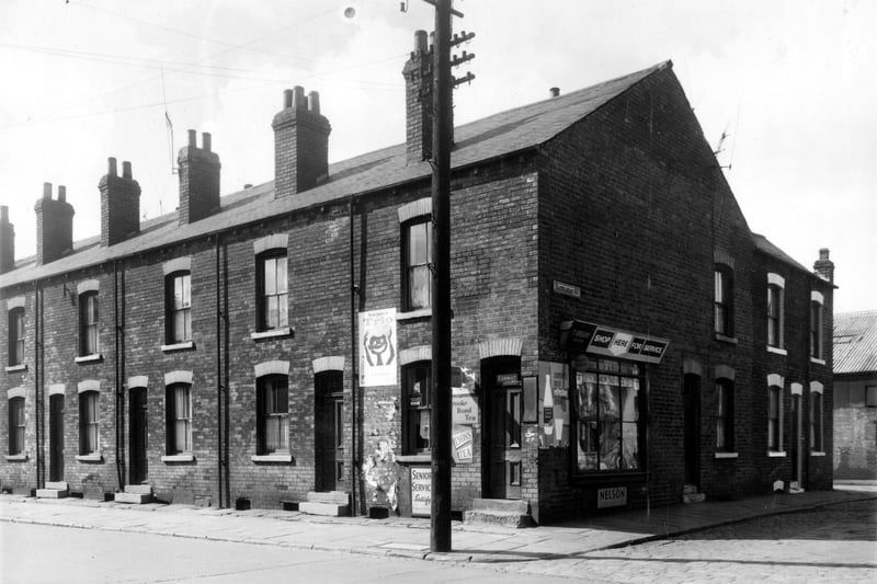 Looking across Clarence Road at the junction with Hazelhead Street. On the far left is no 19 Clarence Road and no 27 is T Gregory's Grocer on the corner. The terraced houses are through with the exception of the Grocers and the backs can be accessed on Atkinson Street, although are numbered differently. Albert Glass Works can partly be seen far right.