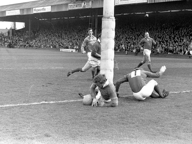 Mick Shoebottom scores a try for Leeds against Hull Kingston Rovers with Rose and Coupland of Hull failing to stop him. Although the try was disallowed Leeds won by 47-5. The other Leeds player in the background is Bernard Watson.