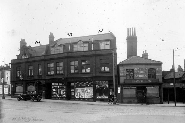 Old properties at the junction of York Road with Marsh Lane. Pictured on the south side of York Road, from left, are The Simpsons Arms, a Tetley public house, landlord John Hanmore at number 4; then number 4A, occupying the upper storey of the building premises is J.Brayshaw and sons, wholesale clothiers. Number 2A is a double fronted chemist's shop, J.Lancaster and son. At number 2, John Grayshon has a pork butchers. On the right, at the junction and addressed as Marsh Lane, is Junction Clothing Stores run by Sidney Mathers, Outfitter. This occupies numbers 116, 118 and 120 on the south-east side. These properties on the junction are on a site later occupied by the Woodpecker Inn.