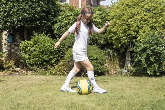 Tess Dolan, 8, has become an Internet sensation after being filmed dancing at the England Women’s game last night in Sheffield, pictured at her home in West Yorks, Jul 27 2022.  See SWNS story SWLEfan. A young England fan who captured the hearts of the nation with her joyful celebration is hoping to roar the Lionesses on to Euros success in the final on Wembley. Tess Dolan, eight, warmed the hearts of tv viewers when cameras caught her singing and dancing to Sweet Caroline after England smashed Sweden 4-0 at Bramhall Lane. Now the footy-mad youngster hopes to be at Wembley on Sunday when Sarina Wiegman's side take on the winners of France vs Germany. And while she insists she 'can't predict the future', Tess said: "I have a lot of faith in them to win. I feel like they have a big chance of beating either of them.  
