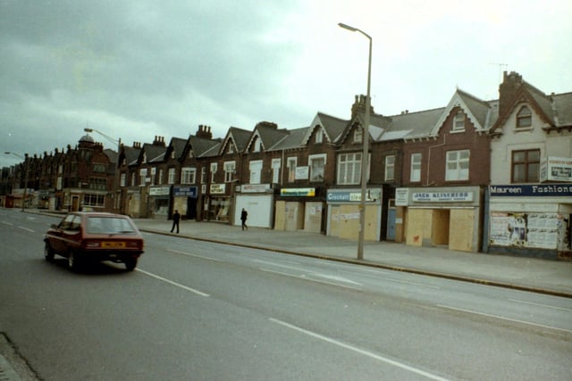 Roundhay Road from near Harehills Corner. Shops visible include the Trustee Savings Bank, Abbey National Building Society, GB Auto Centre, Robinson's Travel, Crockatt Cleaning, Jack Klineberg opticians and Maureen Fashions.
