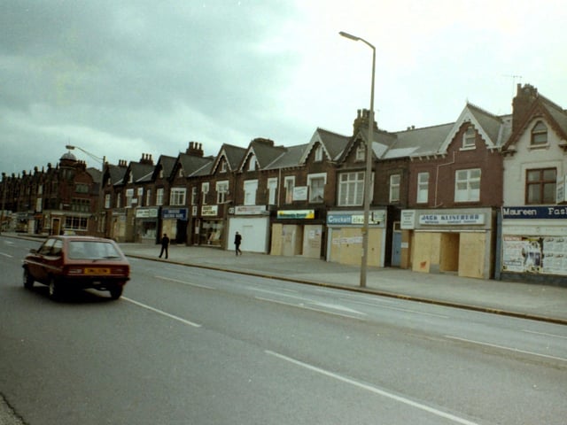 Roundhay Road from near Harehills Corner. Shops visible include the Trustee Savings Bank, Abbey National Building Society, GB Auto Centre, Robinson's Travel, Crockatt Cleaning, Jack Klineberg opticians and Maureen Fashions.