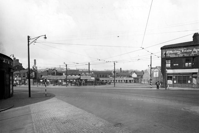 Chapeltown Road at the junction with Manor Street in July 1951, showing timber merchants A.D. Ableson. On the right is A. & F. Moseley, Estate Agents. The junction is interlaced with overhead tram cables.