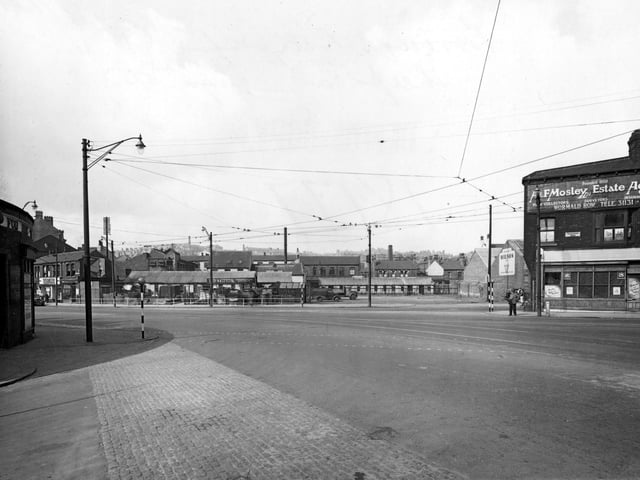 Chapeltown Road at the junction with Manor Street in July 1951, showing timber merchants A.D. Ableson. On the right is A. & F. Moseley, Estate Agents. The junction is interlaced with overhead tram cables.
