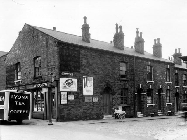 Two shops on Green Lane, partially obscured by a Lyons tea and coffee delivery van. They are Sam's boot and shoe repairs and a grocers. The photo dates back to May 1959.