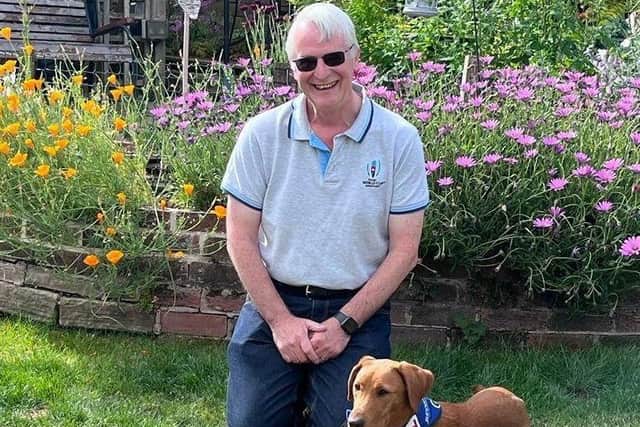 Paul Helliwell with trainee support dog Corey