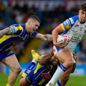 Leeds Rhinos' Jack Sinfield takes on John Bateman, of Warrington Wolves, at Magic Weekend. Picture by Olly Hassell/SWpix.com.