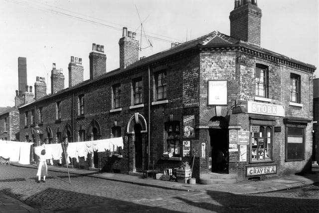 Carlisle Street runs from the left edge of this view where a chimney belonging to T.F. and J.H. Braime Ltd, sheet metal works on Hunslet Road is visible in the background. On the right edge is Holdsworth Street, number 5 is J. Firths grocers offering a wide range of goods including Best Potatoes, 4lbs for 1/-. Number 7 follows, a now disused fish and chip shop which had been the business of Thomas Harvey. Pictured in September 1958.