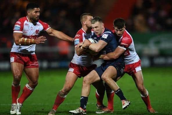 Harry Newman is tackled during Leeds Rhinos' defeat at Hull KR. Picture by Jonathan Gawthorpe.