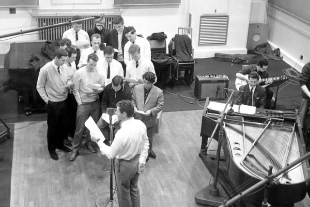 April 1964 and Leeds United footballers are pictured in a recording studio with Ronnie Hilton. Their record, the Leeds Calypso, was later released as a single.