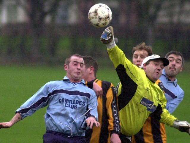 Anthony Dobson of Fieldhead Hospital punches clear challenged by Jeff Johnson of Snydale Athletic Reserves during  a Wakefield League Division 1 Cup clash in December 2000.
