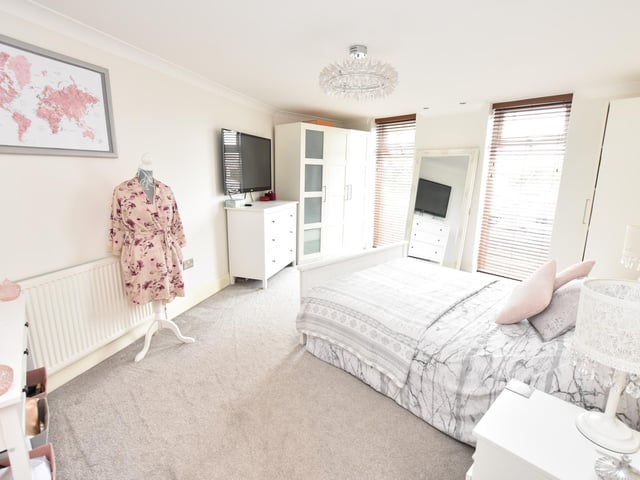 An occasional attic room is accessed by a drop-down ladder and is carpeted and fitted with hanging rails for extra storage. The CCTV and gas central heating boiler are also housed here.