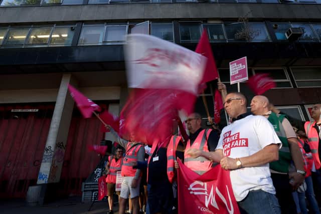 Postal workers from the Communication Workers Union (CWU) on the picket line at the Royal Mail Whitechapel Delivery Office in east London.