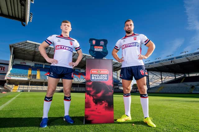 England duo Harry Newman - of Leeds Rhinos - and Mike McMeeken, who will join Wakefield Trinity in pre-season, with the ABK Beer Test Series trophy at AMT Headingley ahead of Saturday's clash with Samoa. Picture by Allan McKenzie/SWpix.com.