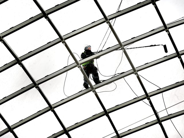 The glass roof gets a final cleaning ahead of opening. There are 1,902 separate panes of glass the dome roof and 918 LED lights.