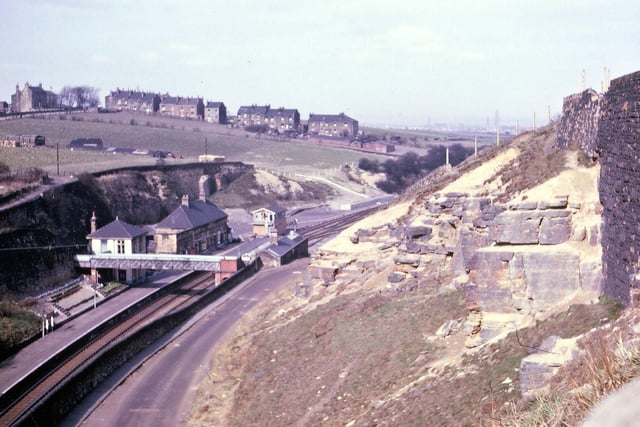 Looking towards Morley Low Station and Daisy Hill from the station steps along the path passing by the Miners' Arms in April 1962. The houses from the brow of the hill sloping down to the railway line are still occupied, but there is no new building as yet on this part of the hill. Much of the land is being used for market gardening. Some of the shaping of the sandstone blocks on the right hand side looks to date back to the era of Morley Main Colliery whose spoil heap covered much of the land behind the right hand wall.