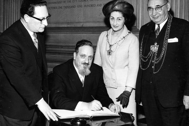 The Chief Rabbi, the Very Rev. Dr. Immanuel Jacobvits, is welcomed to Leeds by the Lord Mayor, Ald Joshua S. Walsh, during a reception at the Civic Hall in May 1967. The Chief Rabbi, making his first visit to Leeds to meet members of the Jewish community, signs the visitors book watched by the Lord Mayor and Lady Mayoress.