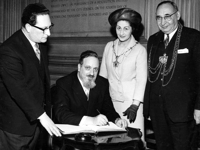 The Chief Rabbi, the Very Rev. Dr. Immanuel Jacobvits, is welcomed to Leeds by the Lord Mayor, Ald Joshua S. Walsh, during a reception at the Civic Hall in May 1967. The Chief Rabbi, making his first visit to Leeds to meet members of the Jewish community, signs the visitors book watched by the Lord Mayor and Lady Mayoress.