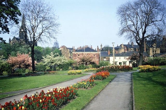 A view along the paths to the roundabout in the centre of the Hopkins Gardens and out to the shops on Queen Street in May 1970.
