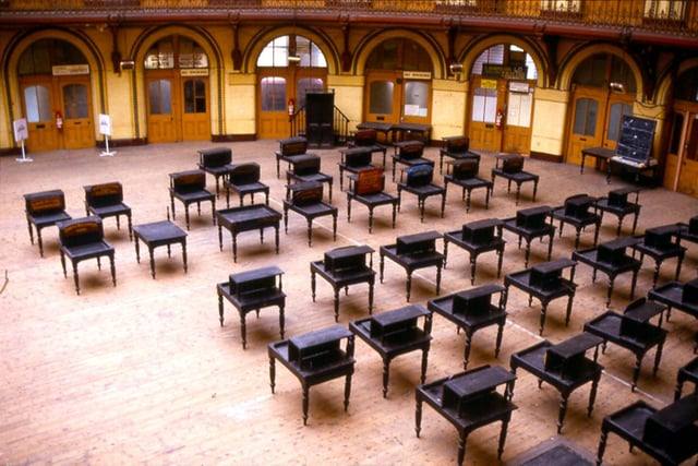 The individual trader's desks arranged across the ground floor of the Corn Exchange. The Corn Exchange was redeveloped in 1990 to provide speciality shops and a basement cafe. The building, elliptical in shape, was originally designed by Cuthbert Brodrick and opened on 28th July 1863.