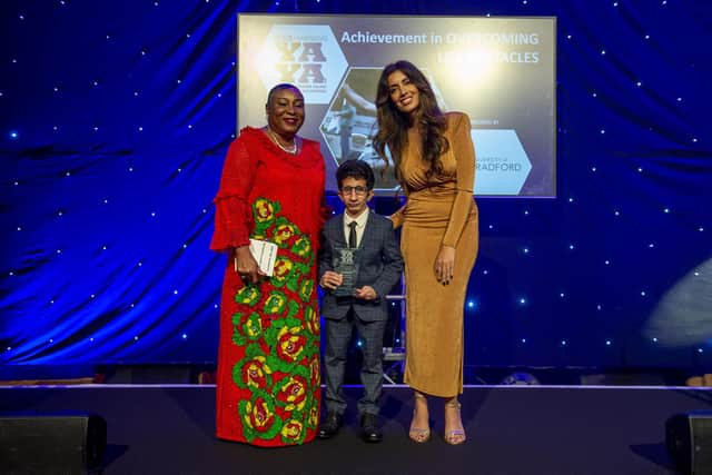 Achievement in Overcoming Life Obstacles winner Muhammad Waqar Ahmed (centre) receiving the award from Professor Uduak Archibong MBE  (left), with YAYAs host Noreen Khan (right). PIcture: Roger Moody