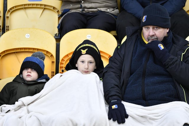 Mansfield Town fans try to keep warm.